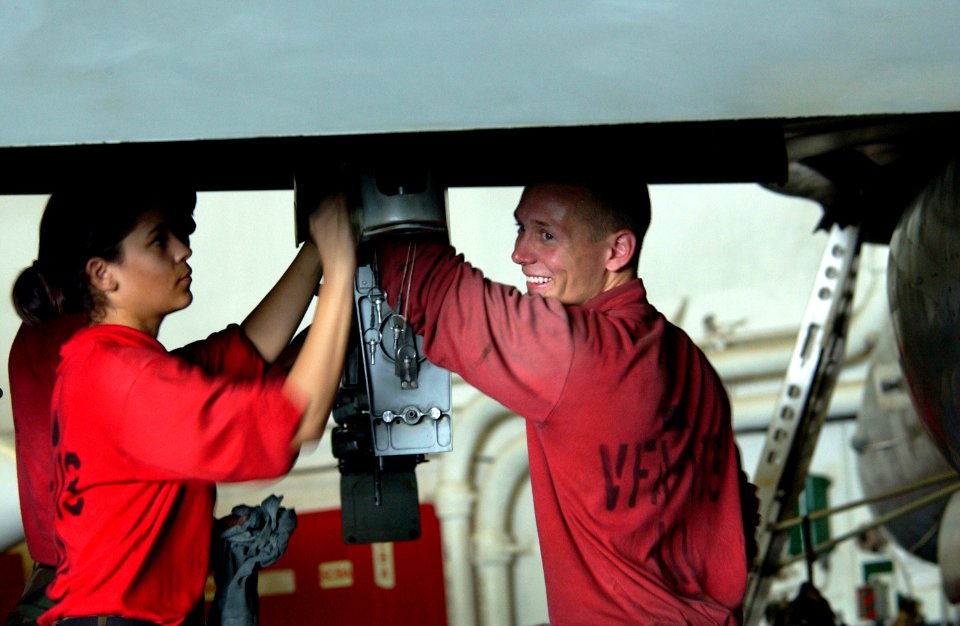 US Navy 060527-N-7526R-087 Aviation Ordnanceman Airman William Gunter-Stockman laughs at a joke as he and other members assigned to the Stingers of Strike Fighter Squadron One One Three (VFA-113) clean the pylon of an F-A-18C