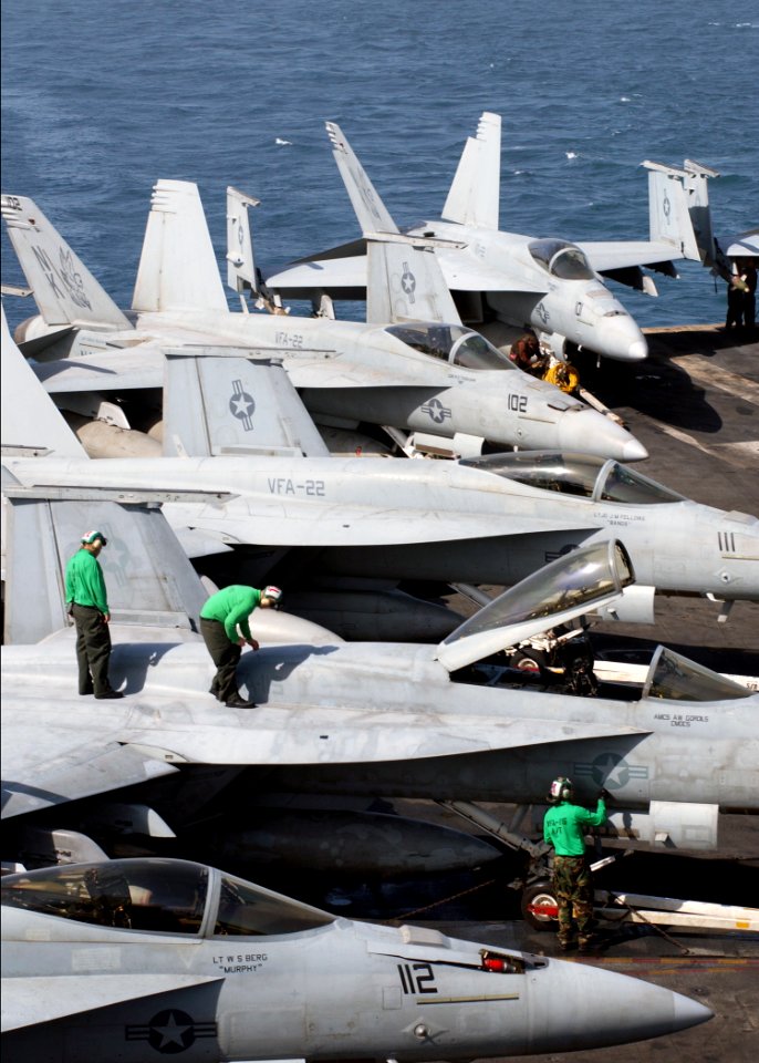 US Navy 060521-N-7526R-001 Sailors assigned to Strike Fighter Squadron Two Two (VFA-22) perform routine maintenance on an F-A-18E Super Hornet aboard the Nimitz-class aircraft carrier USS Ronald Reagan (CVN 76)