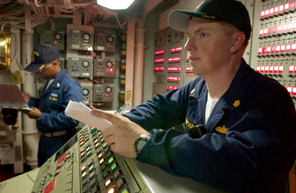 US Navy 060607-N-9851B-004 Executive Officer USS Tortuga (LSD 46) Lt. Cmdr. Robert S. Thompson, observes a general quarters drill from the Central Control Station (CCS) aboard the ship