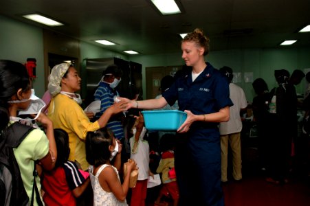 US Navy 060608-N-3714J-029 Navy Hospital Corpsman 2nd Class Tracy Scott, of Largo, Fla., distributes toothbrushes to children during a Medical and Dental Civil Action Project held aboard the U.S. Military Sealift Command (MSC)