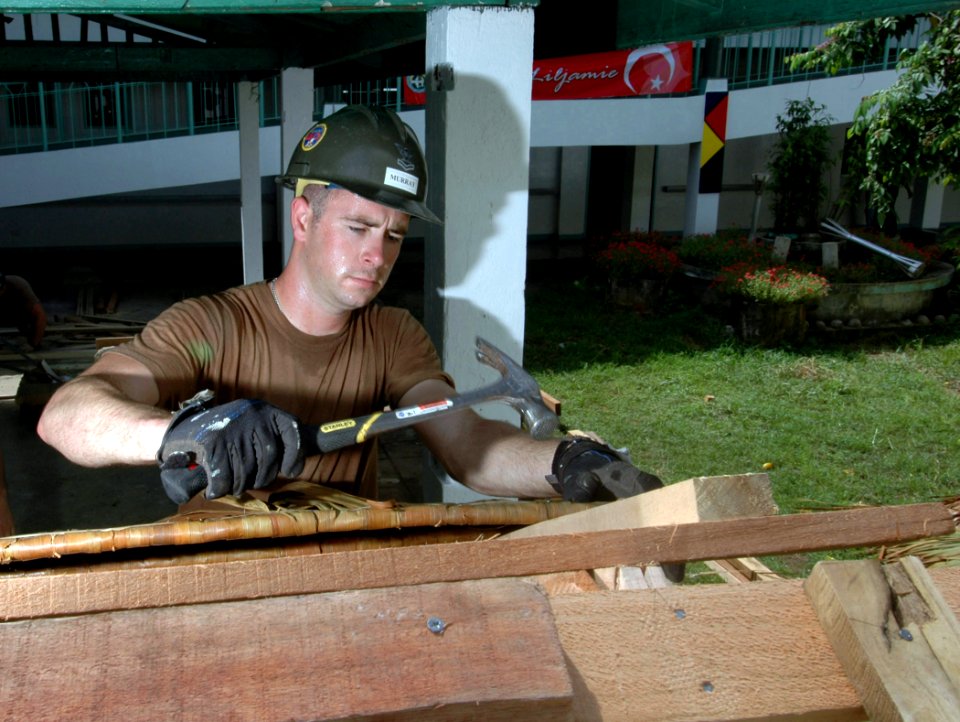 US Navy 060607-N-3532C-028 Navy Builder 2nd Class Shane Murray, a Poughkeepsie, N.Y., native and Seabee with Naval Mobile Construction Battalion Four Zero (NMCB-40), builds a table at Sulu Provincial Hospital