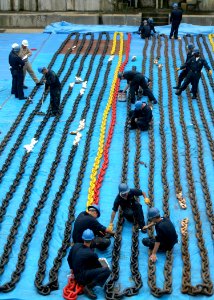 US Navy 060616-N-4953E-004 Boatswain's Mates paint the anchor chains aboard the guided-missile destroyer USS Stethem (DDG 63), while the ship is in the dry dock