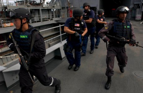 US Navy 060606-N-9851B-012 A combined U.S. and Republic of Singapore Navy (RSN) visit, board, search and seizure (VBSS) team make their way to the flight deck of amphibious dock landing ship USS Tortuga (LSD 46)