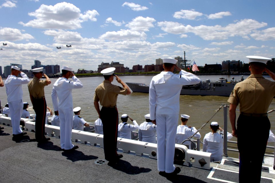 US Navy 060524-N-7676W-155 Sailors and Marines aboard the amphibious assault ship USS Kearsarge (LHD-3) render honors during the parade of ships at the start of Fleet Week New York City 2006