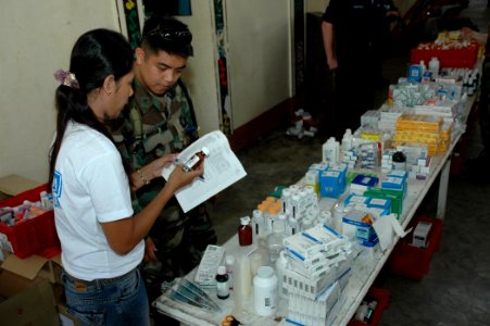 US Navy 060611-N-1577S-065 Hospital Corpsman 2nd Class Gabriel Obedoza of San Diego refills a prescription at a Medical and Dental Civil Action Project (MED-DENCAP)