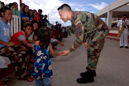 US Navy 060612-N-3153C-013 Air Force Staff Sgt. Joseph Copado, a hospital technician with the Medical Treatment Facility aboard the U.S. Military Sealift Command (MSC) Hospital Ship USNS Mercy (T-AH 19), asks a young girl to da