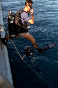 US Navy 060607-N-4205W-010 Cpl. Lau Ming Kwan from the Republic of Singapore Navy (RSN) steps off the side of rescue and salvage ship USS Salvor (ARS 52)