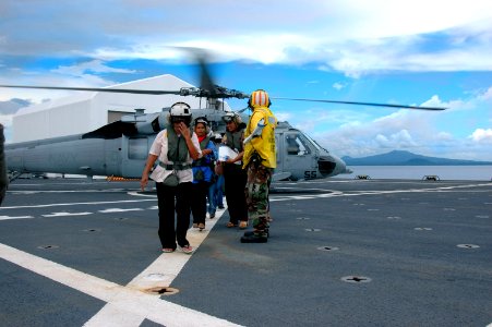 US Navy 060603-N-2832L-099 Patients to receive health care arrive by helicopter to the U.S. Military Sealift Command (MSC) Hospital ship USNS Mercy (T-AH 19)