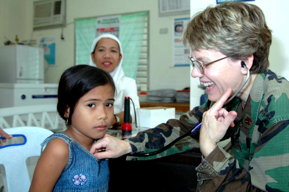 US Navy 060613-N-3532C-034 Air Force Maj. Valerie Clegg, a pediatrician with the Medical Treatment Facility aboard the U.S. Military Sealift Command (MSC) Hospital Ship USNS Mercy (T-AH 19), examines a young girl