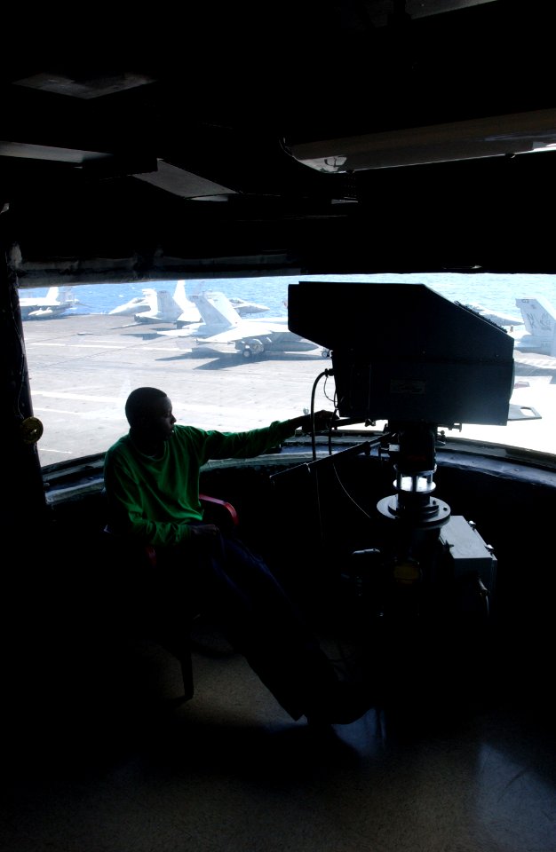 US Navy 060622-N-7730P-016 Fireman Kelby Mungai stands watch with the camera overlooking flight operations