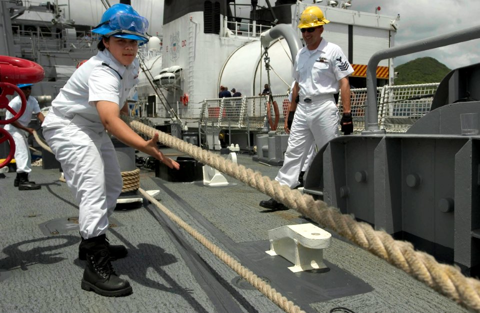 US Navy 060627-N-9851B-001 Seaman Carmin Killingbeck heaves in a mooring line as rescue and salvage ship USS Salvor (ARS 52) departs Thailand