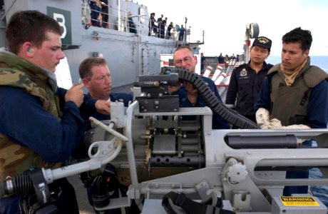 US Navy 060605-N-9851B-014 Sailors clear and safe a 25mm gun as Republic of Singapore Navy Capt. Wee Hong Tat observes on the deck of amphibious dock landing ship USS Tortuga (LSD 46), following a weapons firing exercise