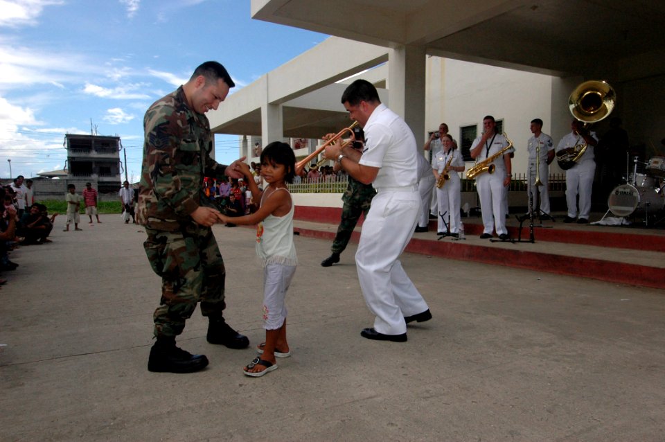 US Navy 060612-N-3153C-019 Air Force Staff Sgt. Joseph Copado, a hospital tech with the Medical Treatment Facility aboard the U.S. Military Sealift Command (MSC) Hospital Ship USNS Mercy (T-AH 19), dances with a young girl