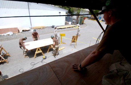 US Navy 060614-N-0411D-101 Utilitiesman 2nd Class Richard Cruikshank of Prairie Grove Ark. waits for fellow Seabees from Naval Mobile Construction Battalion Seven (NMCB-7)