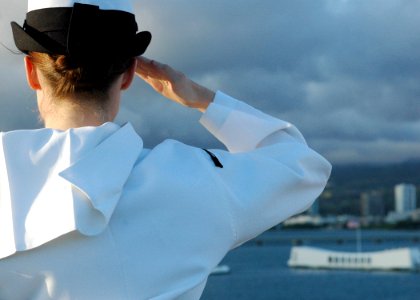 US Navy 060628-N-5627R-790 A Sailor aboard the Nimitz-class aircraft carrier USS Ronald Reagan (CVN 76) renders a hand salute to the USS Arizona Memorial as the ship arrives in Pearl Harbor