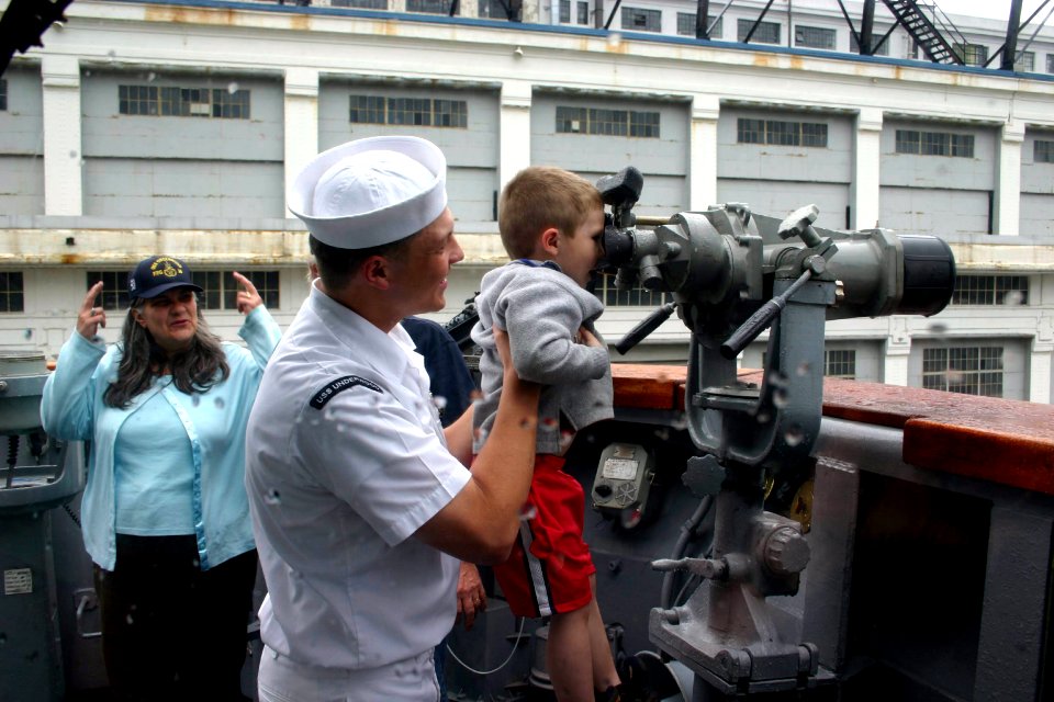 US Navy 060608-N-8110K-100 Boiler Technician 3rd Class Karl Martin assigned to the guided-missile frigate USS Underwood (FFG 36) reunites with his son and parents immediately following the ships docking at the Black Falcon Pier