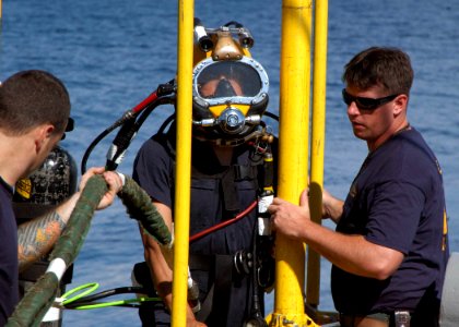 US Navy 060606-N-4205W-004 Chief Navy Diver Matthew Stevens and Navy Diver 1st Class Kevin Parsons stage handle Master Sgt. David Ling from the Republic of Singapore Navy (RSN) prior to conducting a dive