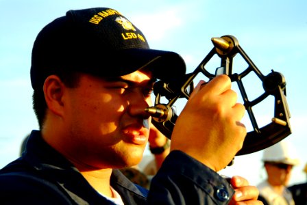 US Navy 060530-N-4772B-067 Midshipman 1st Class Jushua Moore uses a stadimeter on the bridgewing of the amphibious dock landing ship USS Harpers Ferry (LSD 49) during an underway replenishment