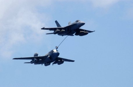 US Navy 060701-N-4776G-028 During air power demonstration, an F-A-18E Super Hornet assigned to Strike Fighter Squadron Twenty Two (VFA-22) performs an in-flight refueling with an EA-6B Prowler
