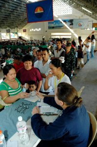 US Navy 060611-N-1577S-178 Hospital Corpsman 2nd Class Leslie-Christine Wennihan of Meriden, Kan., conducts an eye exam at a Medical and Dental Civil Action Project (MED-DENCAP)