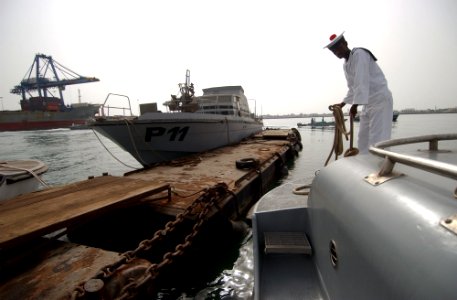 US Navy 060615-N-0411D-021 Commandant Awalo, a member of the crew of Djiboutian Patrol Vessel 03, ties the small boat up after the ceremonies at the port
