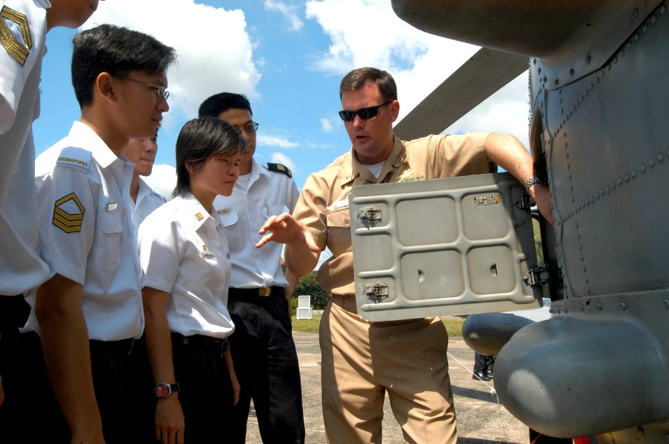 US Navy 060601-N-4205W-008 Officer in Charge Anti-Submarine Squadron Light Three Seven (HSL-37) Detachment 5, Lt. Cmdr. Colin Smith, explains the capabilities of the SH-60B Seahawk helicopter
