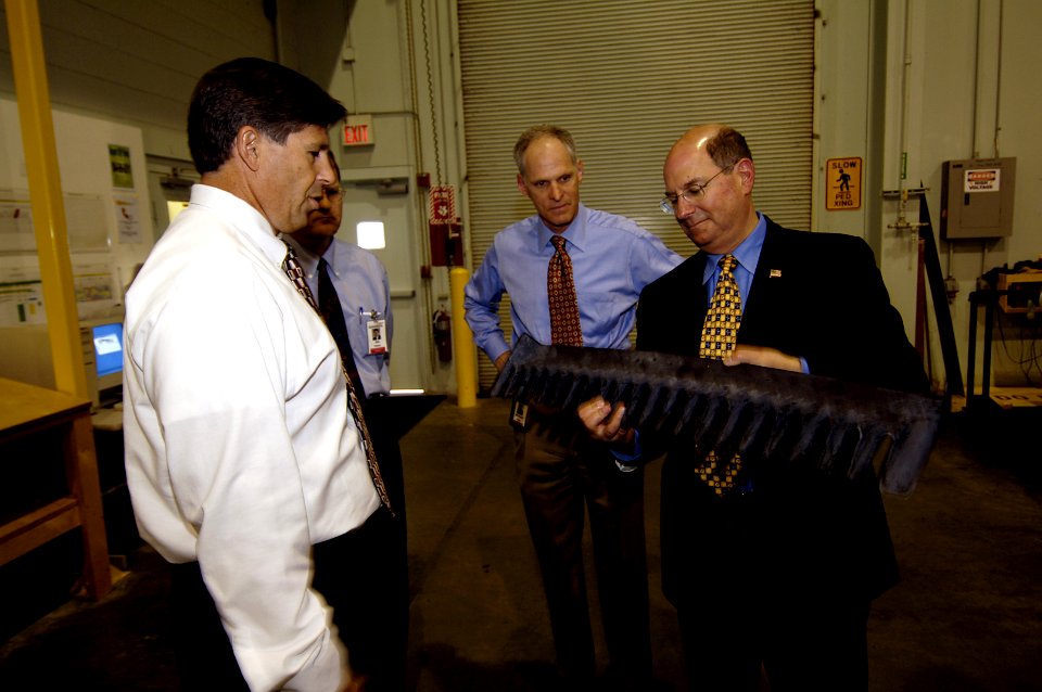 US Navy 060602-N-3642E-008 Secretary of the Navy (SECNAV) the Honorable Dr. Donald C. Winter inspects an exhaust rake that will attach to the whale tale of an Expeditionary Fighting Vehicle (EFV)