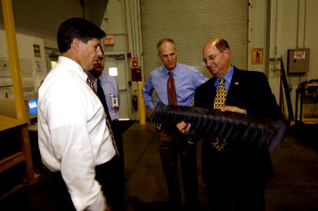 US Navy 060602-N-3642E-008 Secretary of the Navy (SECNAV) the Honorable Dr. Donald C. Winter inspects an exhaust rake that will attach to the whale tale of an Expeditionary Fighting Vehicle (EFV)