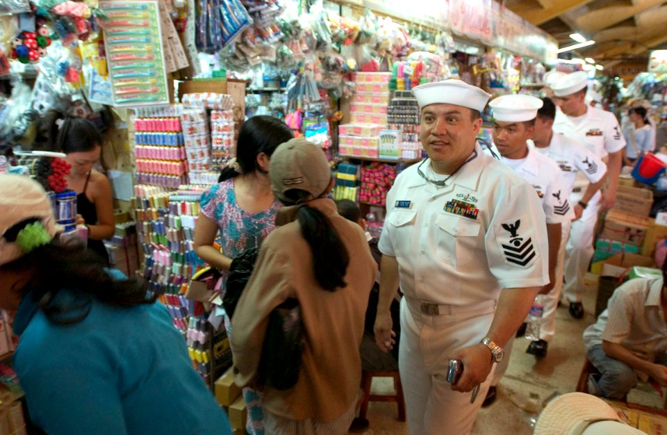 US Navy 060702-N-9851B-005 Sailors assigned to the rescue and salvage ship USS Salvor (ARS 52), walk through the Binh Tay Market
