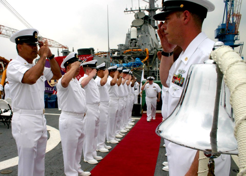 US Navy 060602-N-4953E-012 Senior Chief Boatswain's Mate Ronny Corpuz pipes off Chief Gas Turbine Systems Technician Timothy Krantz as he walks through sideboys during a retirement ceremony