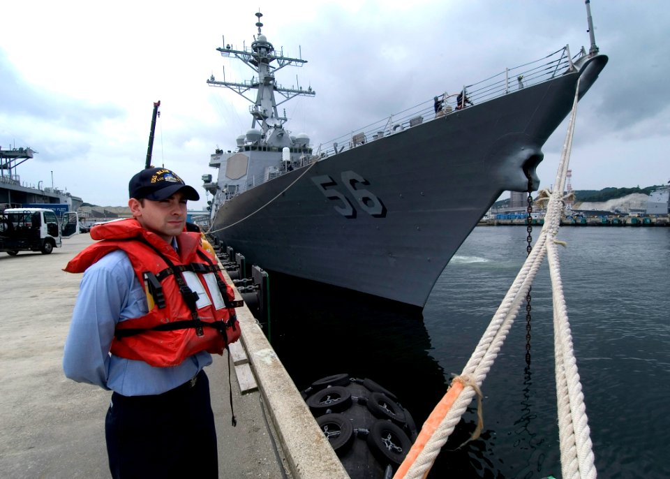US Navy 060608-N-2385R-004 Personnel Specialist Seaman Recruit Anthony Van Dover stands by as a line-handler in preparation for the departure of the guided-missile destroyer USS John S. McCain (DDG 56)