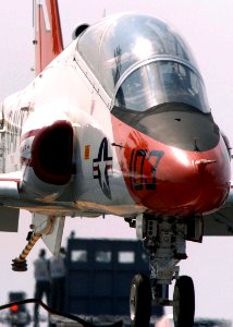 US Navy 060615-N-0490C-001 A naval aviator student releases the arresting wire from the tail hook of a T-45C Goshawk after successfully landing aboard the Nimitz-class aircraft carrier USS Dwight D. Eisenhower (CVN 69)
