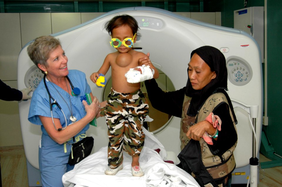 US Navy 060604-N-2832L-048 Diane Speranza, a Project Hope volunteer and emergency room nurse assigned to casualty receiving, prepares a boy on his fifth birthday for doctors
