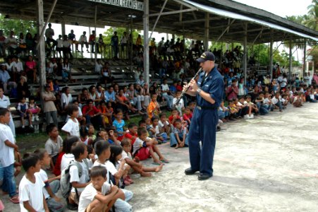 US Navy 060616-N-3532C-128 Musician 2nd Class Ian Charleton, a clarinetist with the U.S. Navy Show Band, entertains local residents at a Medical and Dental Civil Action Project (MEDDENCAP)