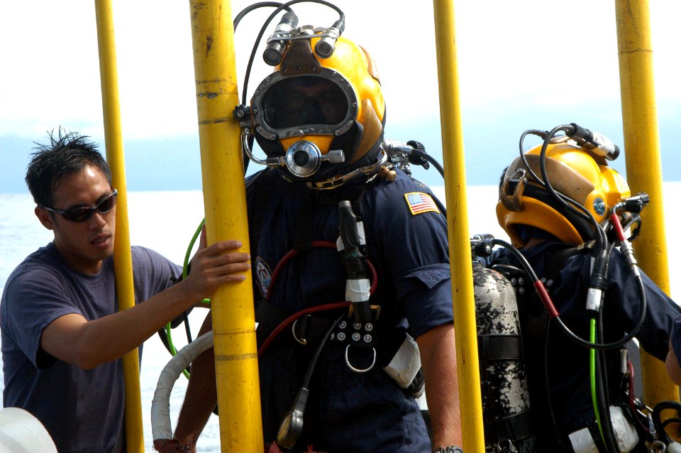 US Navy 060606-N-4205W-009 Master Sgt. David Ling from the Republic of Singapore Navy (RSN) stage handles Gunner's Mate 2nd Class Brian Zenoni and Lt. Chan Tse Chi Grace, RSN, after they conducted a dive