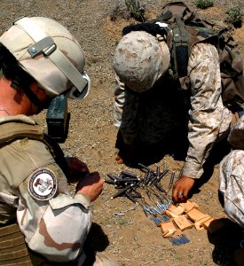 US Navy 060810-N-0411D-023 U.S. Navy Explosives Ordnance Disposal Specialists set excess blasting caps in a place under a sixteen-pound block of C4 explosives during exercise Natural Fire