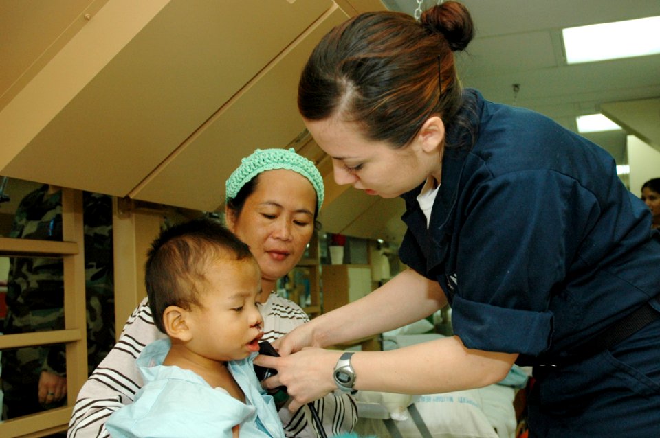 US Navy 060612-N-1577S-014 Navy Hospital Corpsman Rebecca Vargas of Buena Park, Calif., checks the blood pressure of a patient in ward eight aboard the U.S. Military Sealift Command (MSC) Hospital Ship USNS Mercy (T-AH 19)