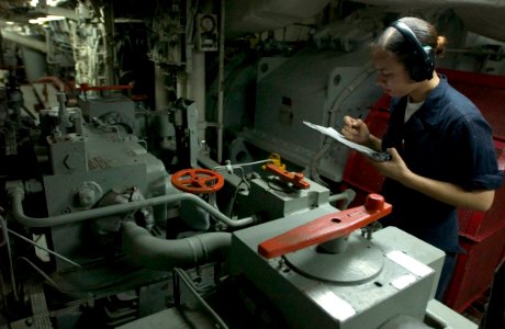 US Navy 060616-N-9851B-012 Engineman Fireman Tiffany Bailey documents engineering checks in the number one main machinery room aboard the amphibious dock landing ship USS Tortuga (LSD 46)