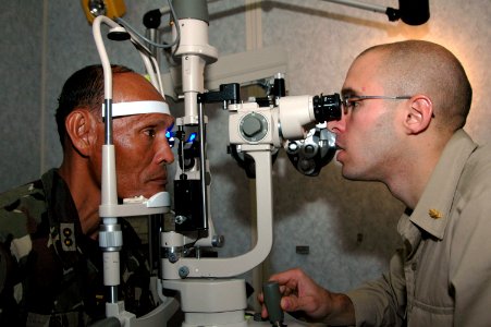 US Navy 060612-N-3532C-005 Navy Lt. Robert Senko, an optometrist assigned to the Medical Treatment Facility aboard the U.S. Military Sealift Command (MSC) Hospital Ship USNS Mercy (T-AH 19), conducts a glaucoma test photo