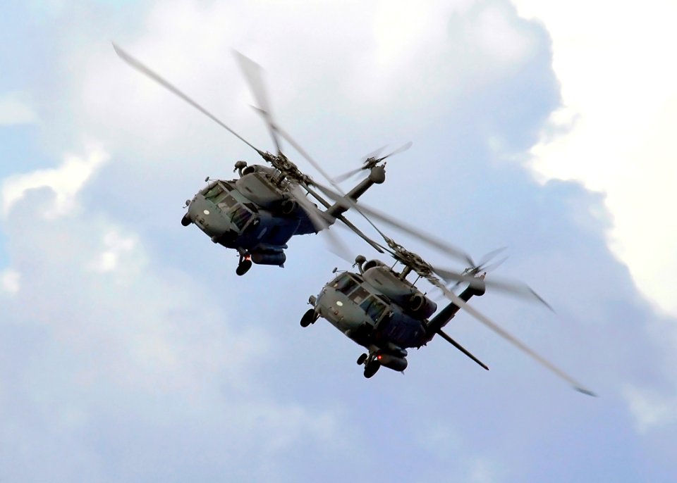 US Navy 060622-N-7981E-010 A pair of SH-60 Seahawk helicopters assigned to the Golden Falcons of Helicopter Anti-Submarine Squadron Two (HS-2) approach the Nimitz-class aircraft carrier USS Abraham Lincoln (CVN 72