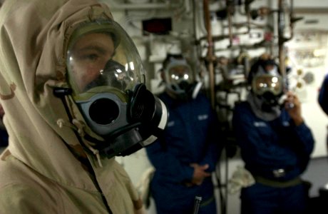 US Navy 060617-N-9851B-006 Seaman Christopher Smith wears an Advanced Chemical Protective Garment (ACPG) before exiting the skin of the ship as part of an external investigation team