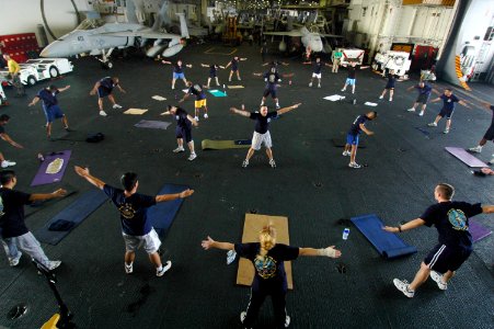 US Navy 060623-N-9389D-172 Conventionally-powered aircraft carrier USS Kitty Hawk (CV 63) Chiefs' Mess Sailors exercise during a physical training (PT) session in the hangar bay during Exercise Valiant Shield 2006
