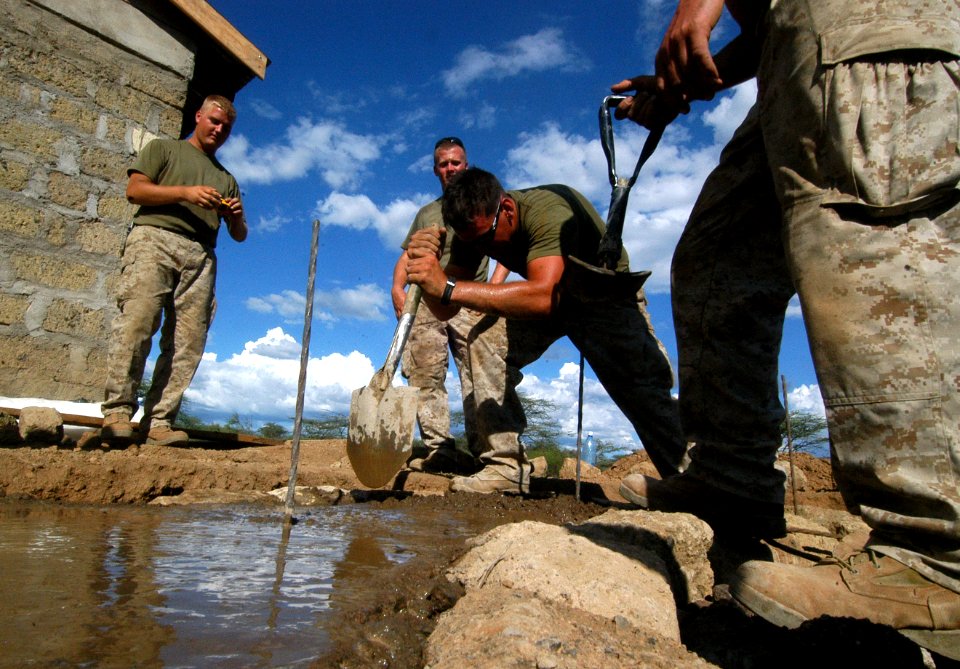 US Navy 060811-N-0411D-016 U.S. Marine Elias Hunerdosse, center, of LaHarpe, Ill., settles mortar in the foundation of a water tower