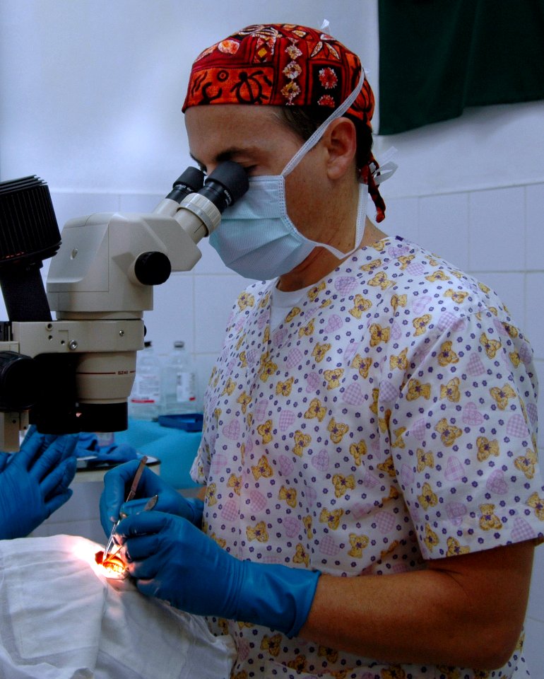US Navy 060613-N-3532C-032 Navy Lt. Cmdr. Frank Bishop, an ophthalmologist with the Medical Treatment Facility aboard the U.S. Military Sealift Command (MSC) Hospital Ship USNS Mercy (T-AH 19), removes a growth from a local res