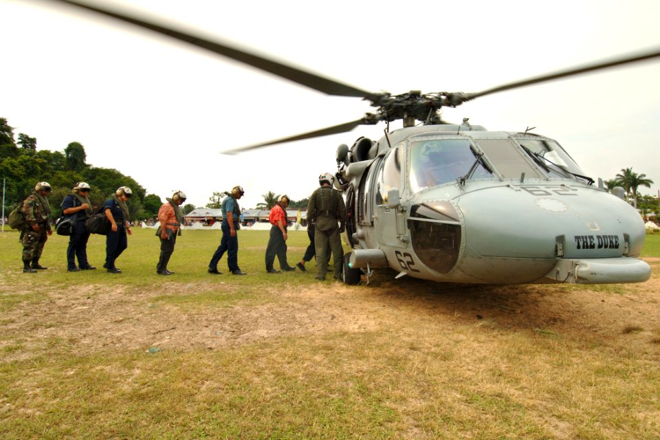 US Navy 060812-N-6501M-096 The Mayor of Tarakan, H. Jusuf SK, members of his staff and other officials prepare to board and MH-60S helicopter, for a tour aboard the Military Sealift Command (MSC) hospital ship USNS Mercy (T-AH
