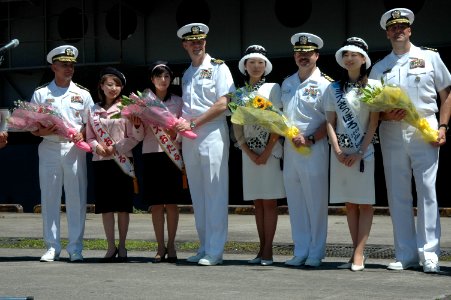 US Navy 060701-N-1332Y-094 Rear Adm. Doug McClain, USS Kitty Hawk (CV 63) Commanding Officer, Capt. Ed McNamee, Capt. Michael McNellis and Commander, Destroyer Squadron One Five, Capt. Robert Girrier, receive flowers as they ar
