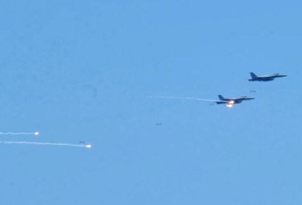 US Navy 060702-N-7730P-084 F-A-18E Super Hornets, assigned to the Fighting Redcocks of Strike Fighter Squadron Twenty Two (VFA-22), perform flight maneuvers during an air power demonstration