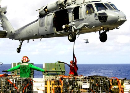 US Navy 060624-N-7981E-073 Aviation Ordnancemen from Weapons Department, G-1 Division attach a cargo pendant to an MH-60S Seahawk assigned to Helicopter Sea Combat Two One (HSC-21)