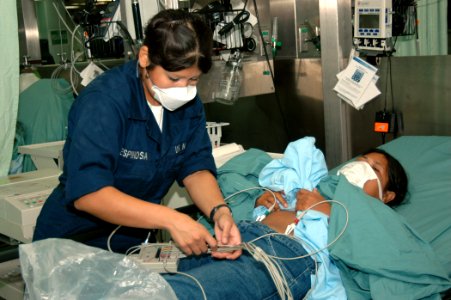 US Navy 060612-N-2832L-058 Navy Hospital Corpsman Melisa Espinosa, of San Antonio, Texas, assigned to the Medical Treatment Facility aboard the U.S. Military Sealift Command (MSC) Hospital Ship USNS Mercy (T-AH 19), prepares a photo