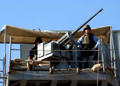 US Navy 060629-N-0780F-004 Crewmembers aboard USS Nashville (LPD 13) man a MK-38 25-mm Machine Gun as they arrive for a routine port visit. Nashville's is the tenth ship in the Austin-class of Amphibious Transport Docks